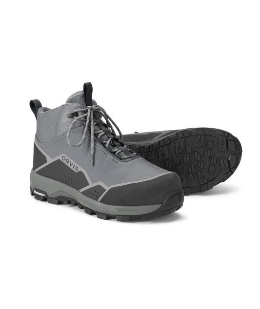A pair of gray and black Orvis mid-cut wading boots, with one boot standing upright and the other lying on its side to show the treaded outsole.