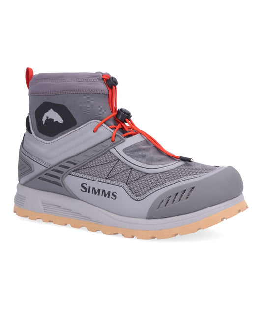 A gray Simms mid-cut fishing boot with bright orange laces and a black logo patch on the side, shown against a plain white background.