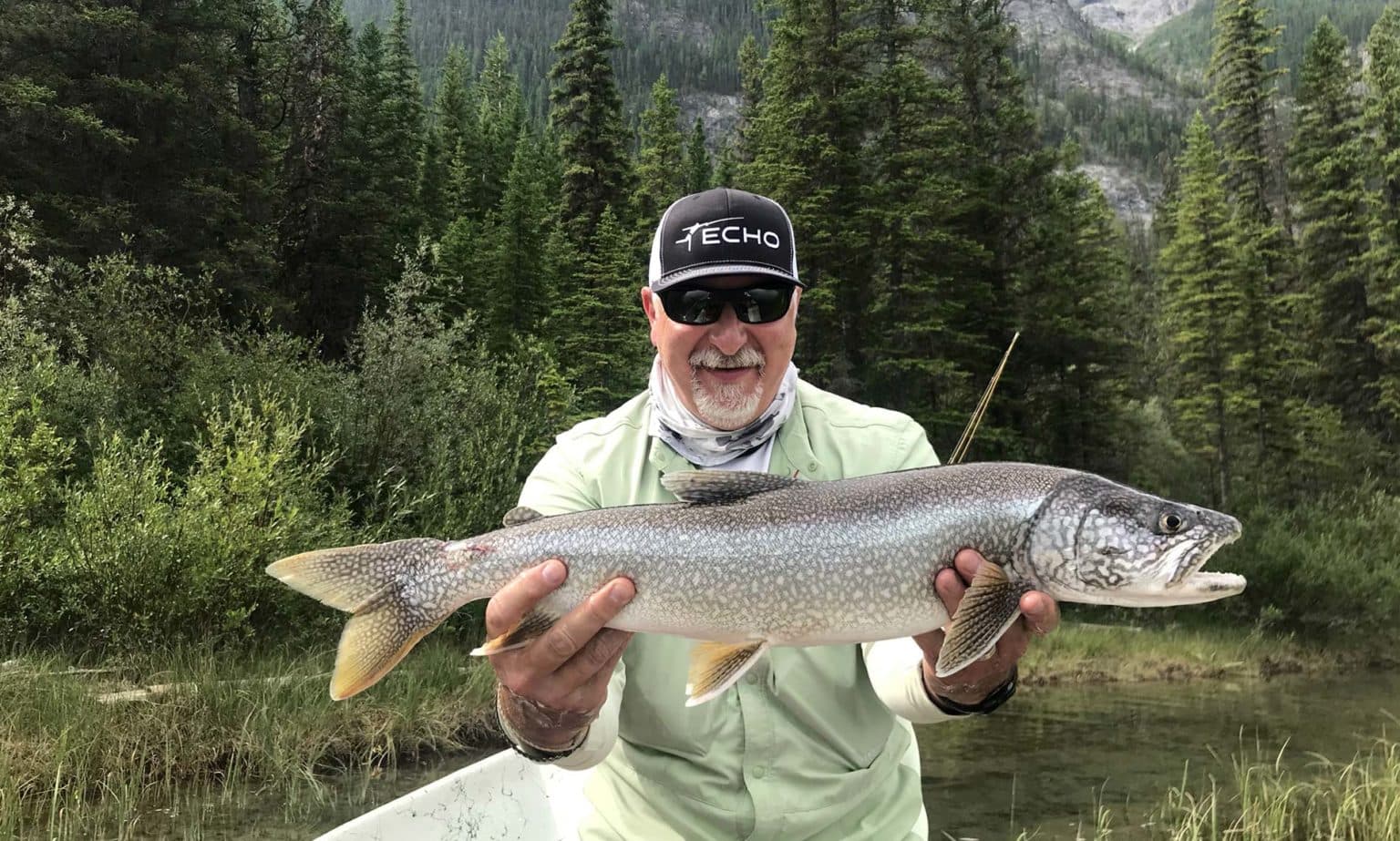 Nick holding a large bull trout on the bow river canmore