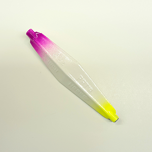 A single fishing lure, translucent white with a bright pink-to-purple gradient at one end and a neon yellow tip at the other.