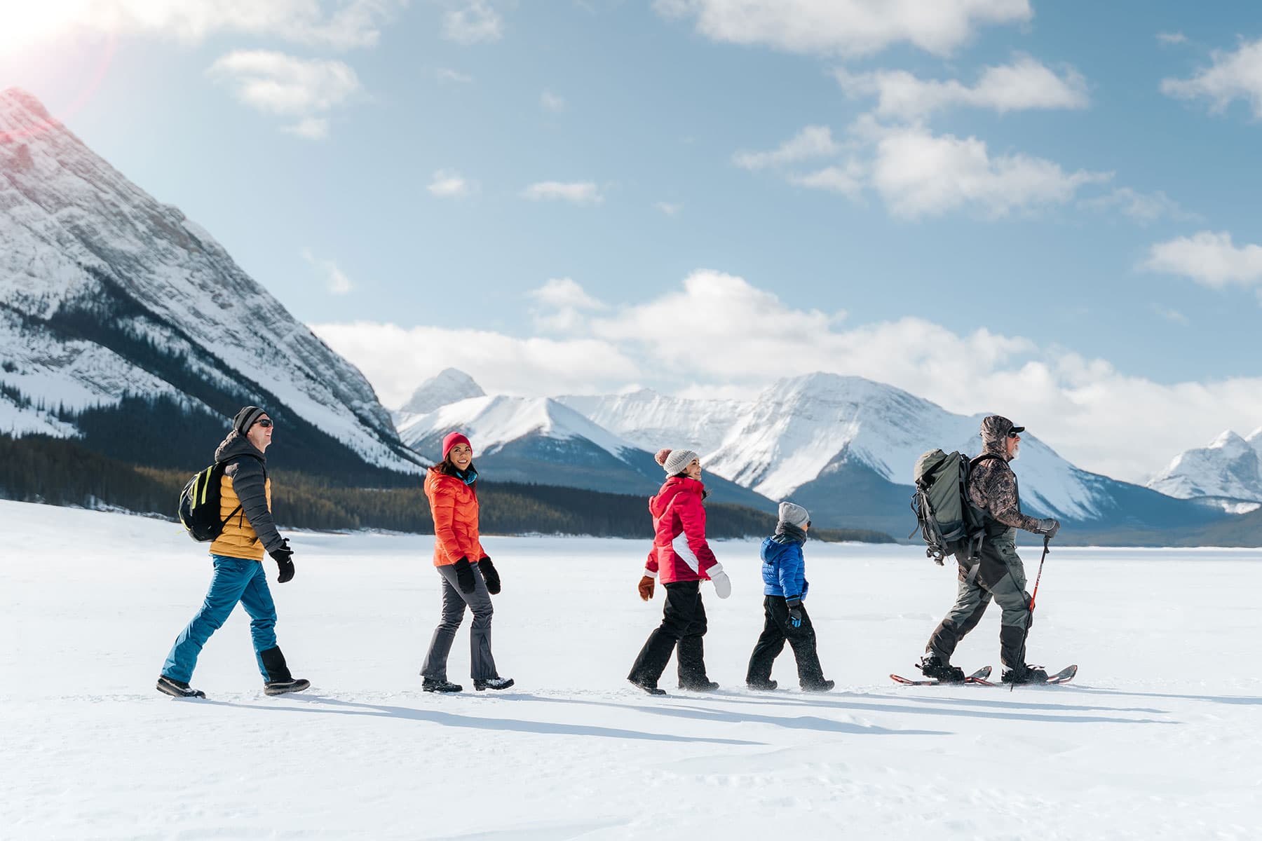 walking to ice fishing on the frozen spray lakes near canmore 